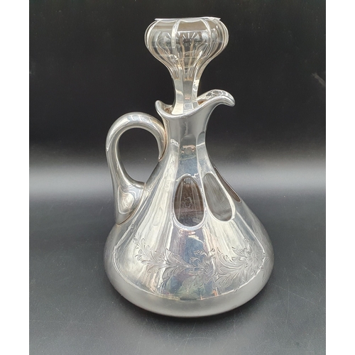 133 - A sterling silver overlaid glass Decanter with floral and leafage engraving, with stopper