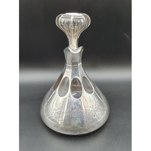 133 - A sterling silver overlaid glass Decanter with floral and leafage engraving, with stopper