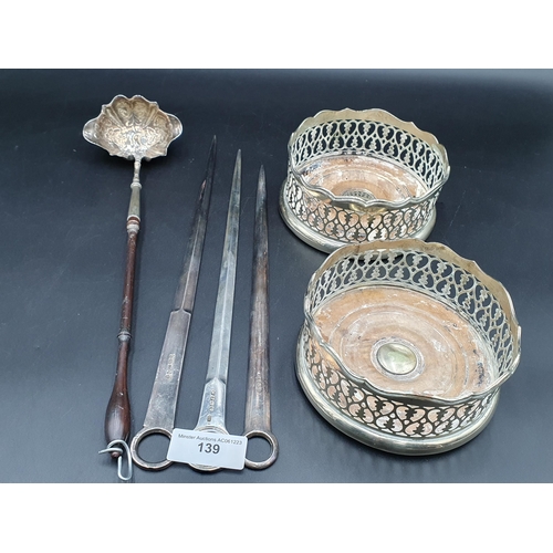 139 - A pair of plated pierced circular Coasters, a silver Meat Skewer, two Meat Skewers and a silver Todd... 