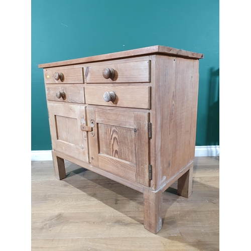 14 - A pine Cupboard fitted four drawers above pair of cupboard doors, raised on square supports, 2ft 10