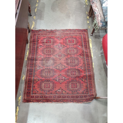 149 - A small Persian Rug with two rows of medallions on a red ground, worn, 4ft 3in x 3ft 5in (R6/R7)