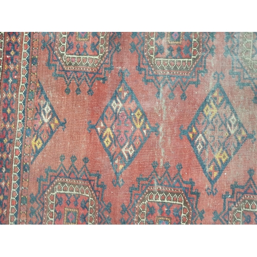 149 - A small Persian Rug with two rows of medallions on a red ground, worn, 4ft 3in x 3ft 5in (R6/R7)