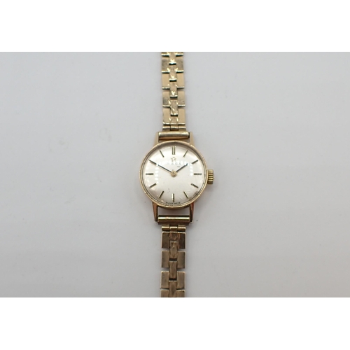 156 - A lady's Omega Wristwatch the silvered dial with hourly baton markers in 9ct gold case, case width a... 