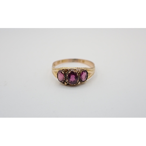 165 - A Garnet three stone Ring set oval-cut stones in 15ct gold, ring size O and a Sapphire and Diamond t... 