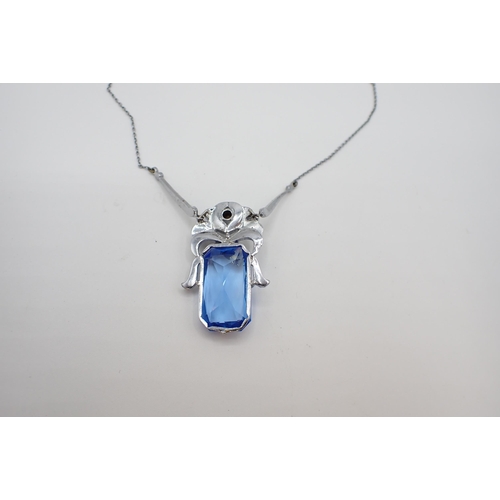 173 - An Art Deco style Necklace set white paste above large blue rectangular glass on fine chain in white... 