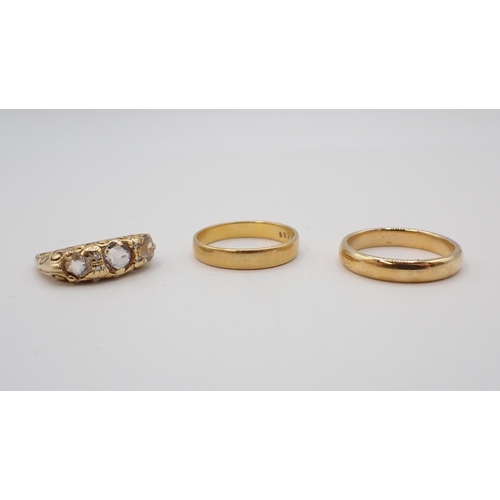 185 - A 22ct gold Wedding Band, approx 3gms, an unmarked gold Wedding Band, approx 4.40gms and a three sto... 