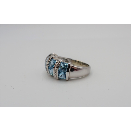 187 - A Blue Topaz and Diamond Ring channel-set eight princess-cut topaz with columns of pavé-set brillian... 