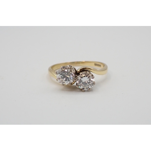 193 - A Diamond Crossover Ring claw-set two brilliant-cut stones, estimated total weight 1ct, in 18ct gold... 