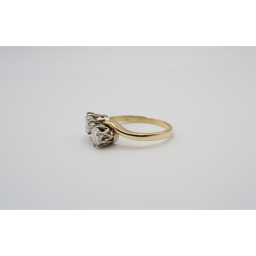 193 - A Diamond Crossover Ring claw-set two brilliant-cut stones, estimated total weight 1ct, in 18ct gold... 