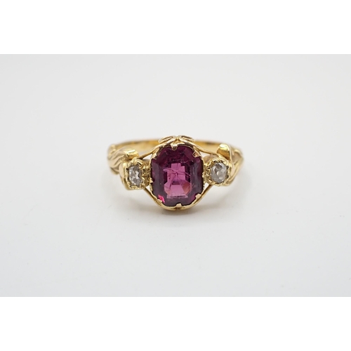 199 - A Garnet and Diamond three stone Ring claw-set step-cut garnet between two old-cut diamond in scroll... 