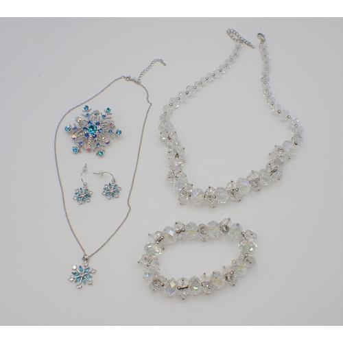 215 - A matching graduated crystal faceted bead Necklace and Bracelet together with a snowflake design Bro... 