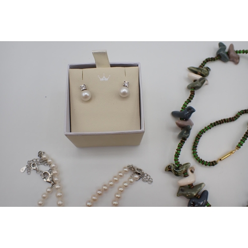 216 - Two strings of graduated Cultured Pearls on silver clasps, a bead and ceramic bird Necklace, a pair ... 