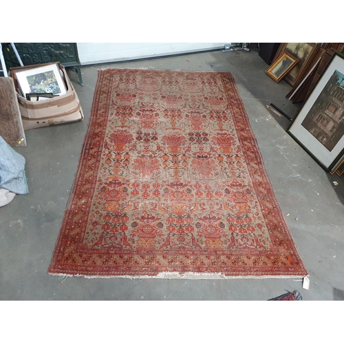 28 - An antique Persian terracotta ground Rug with stylised vases of flowers 9ft 4in L x 5ft 7in W (R9)
