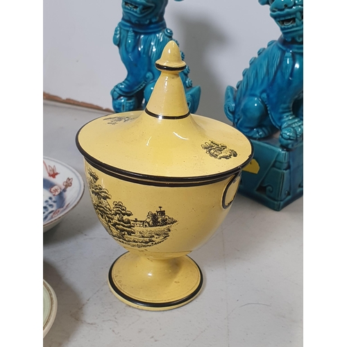 305 - A yellow glazed Pedestal Cup and Cover with transfer print designs, a pair of oriental blue glazed s... 