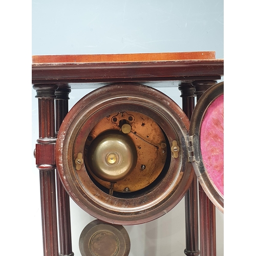 31 - A 19th Century mahogany Mantle Clock with circular movement supported by fluted columns on rectangul... 