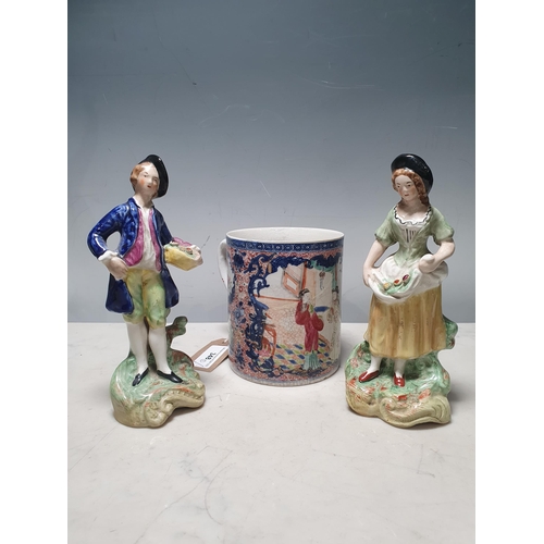 348 - A pair of Staffordshire Figures, and an 18th Century Chinese Mug (A/F and Restored). (R5).