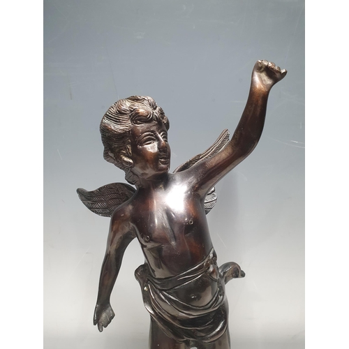 349 - A bronze Statue of a winged Cherub raised on circular base, unsigned, 1ft 2