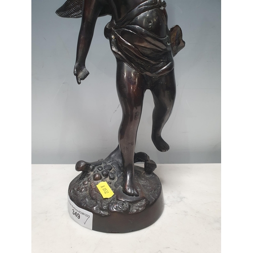 349 - A bronze Statue of a winged Cherub raised on circular base, unsigned, 1ft 2