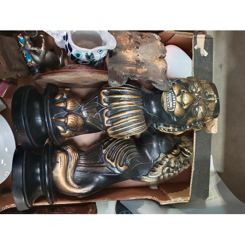 376 - A box of Metalware etc including, two octagonal Wall Mirrors,  a carved wooden Face, two brass Lion ... 