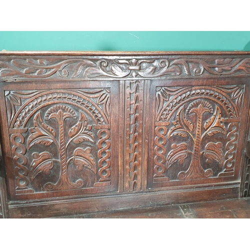 474 - An oak Box Settle with carved panel back, lift up seat, above three panel front with carved applied ... 