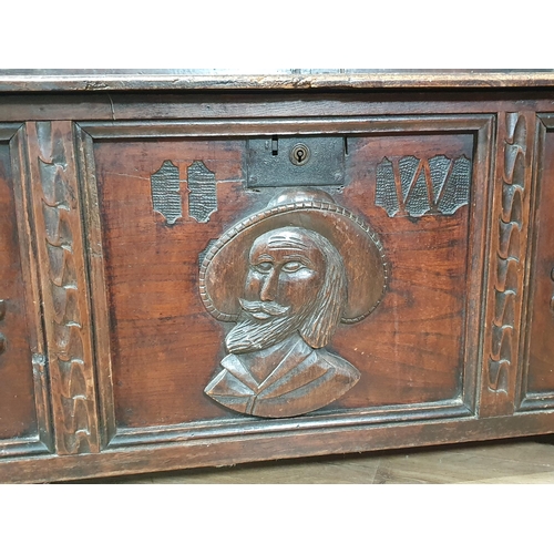 474 - An oak Box Settle with carved panel back, lift up seat, above three panel front with carved applied ... 