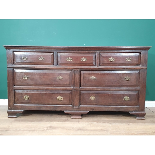 484 - An antique oak Lancashire Chest fitted three short drawers above four long drawers raised on bracket... 