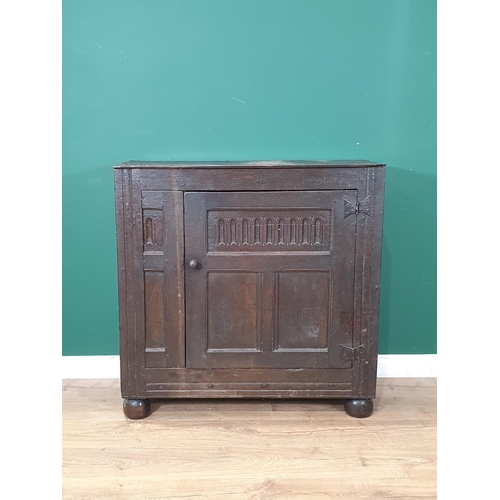 488 - An 18th Century and later oak Cupboard with single panelled door, raised on large bun feet, 3ft 2