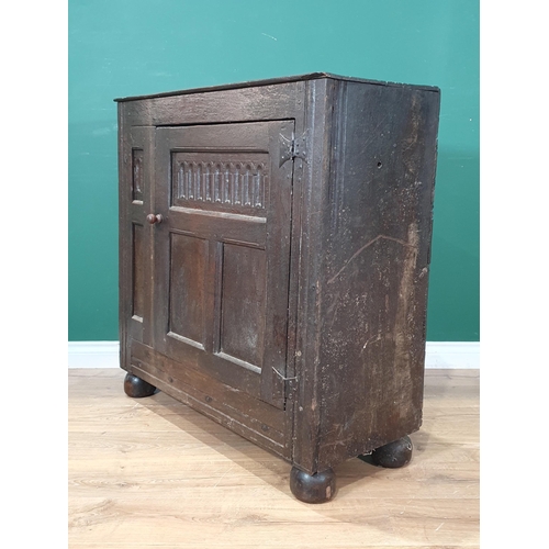 488 - An 18th Century and later oak Cupboard with single panelled door, raised on large bun feet, 3ft 2