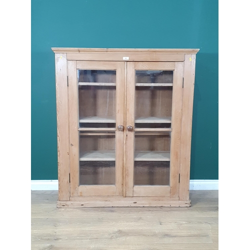 489 - A pine glazed two door Cupboard with three fitted shelves, 4ft 5