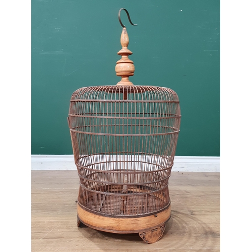 495 - A decorative Oriental Hanging bamboo Birdcage with carved door and three carved supports, 2ft 6