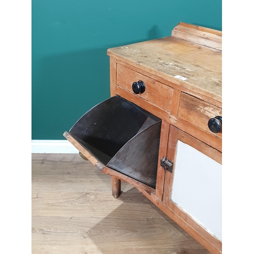 498 - A rustic pine Kitchen Cupboard, fitted two drawers above a single cupboard door and a fall front was... 