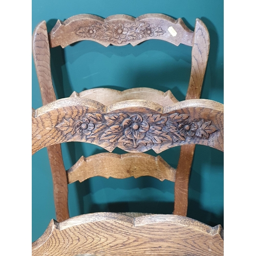 502 - A set of Six bar backed rush seated Dining Chairs with carved floral decoration on splayed supports.... 