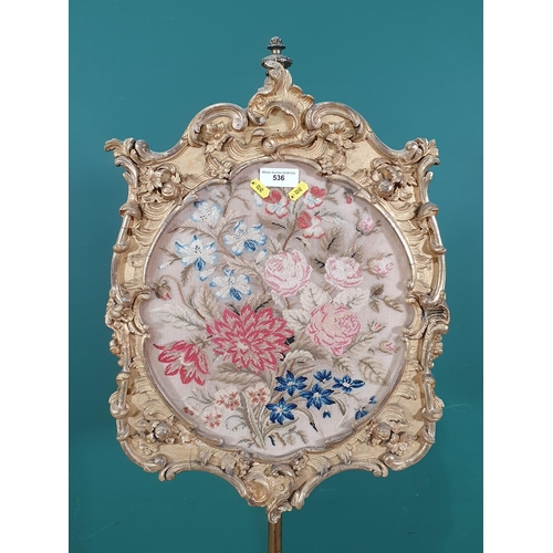 536 - A gilt and brass Pole Screen, with floral decorated tapestry panel, raised on floral and scrolled tr... 