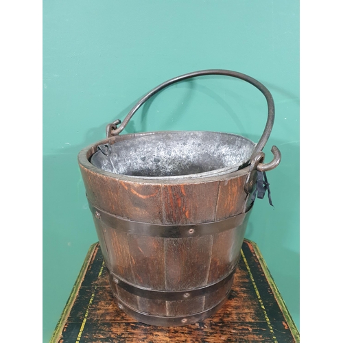 549 - An oak coopered Coal Bucket with swing handle and metal liner, 11