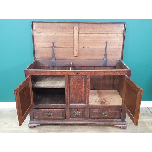 578 - An antique oak Mule Chest, the lift up lid above panelled front that's converted to pair of cupboard... 