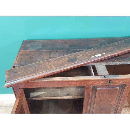 578 - An antique oak Mule Chest, the lift up lid above panelled front that's converted to pair of cupboard... 