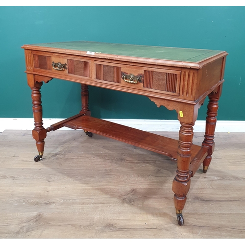 580 - A walnut Writing Table with green inset writing surface with gilt tooled decoration, above a pair of... 