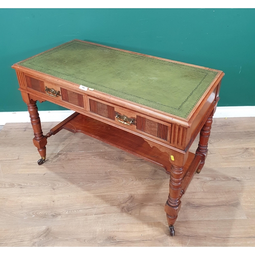 580 - A walnut Writing Table with green inset writing surface with gilt tooled decoration, above a pair of... 