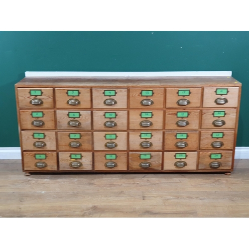 596 - A pine bank of twenty four drawers 5ft 2in W x 2ft 3in H (R8)