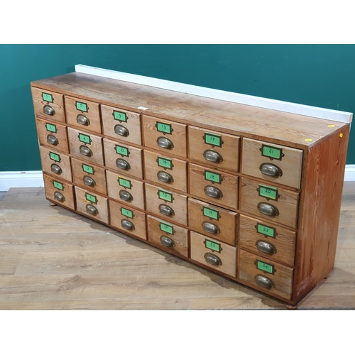 596 - A pine bank of twenty four drawers 5ft 2in W x 2ft 3in H (R8)