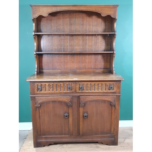 683 - An oak Old Charm Style Dresser and Rack the base fitted two drawers above pair of cupboard doors, 5f... 