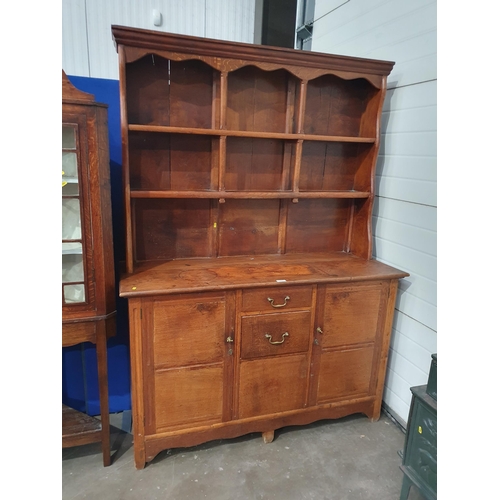 717 - An antique oak Dresser and rack the base fitted pair of cupboard doors flanking two drawers 6ft 7in ... 