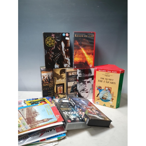 741 - A box of Clint Eastwood and Tintin DVDs, Matchbox Catalogues and Track Planners