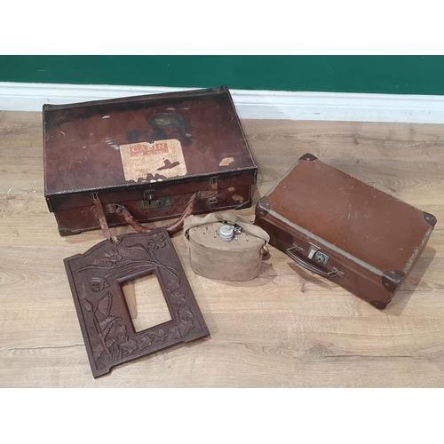 750 - A leather Case containing a small leather case, a canvas covered water Canteen, and a carved Picture... 