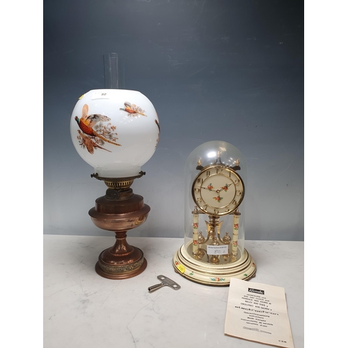 80 - A Kundo 400 day Mantel Clock with floral decoration, under a glass dome, 12in H and a copper Paraffi... 