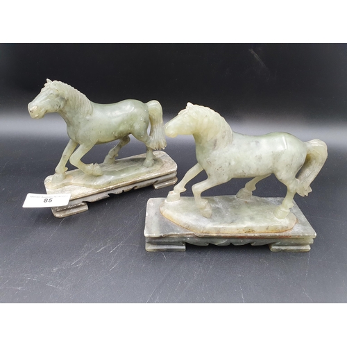 85 - A pair of carved jade type Horses on rectangular plinths, 6in