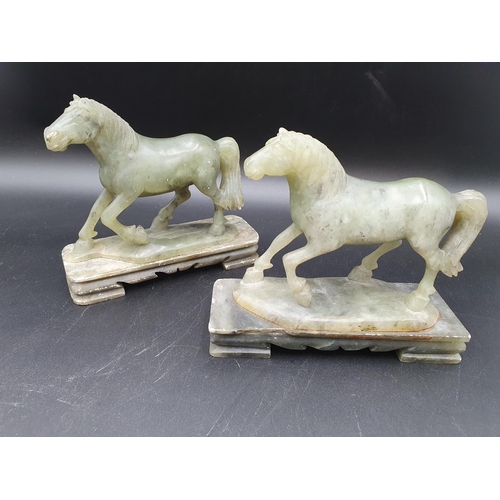 85 - A pair of carved jade type Horses on rectangular plinths, 6in