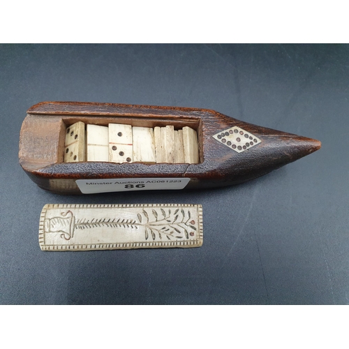 86 - A Treen Box in the form of a shoe with carved bone sliding lid enclosing a miniature set of bone Dom... 