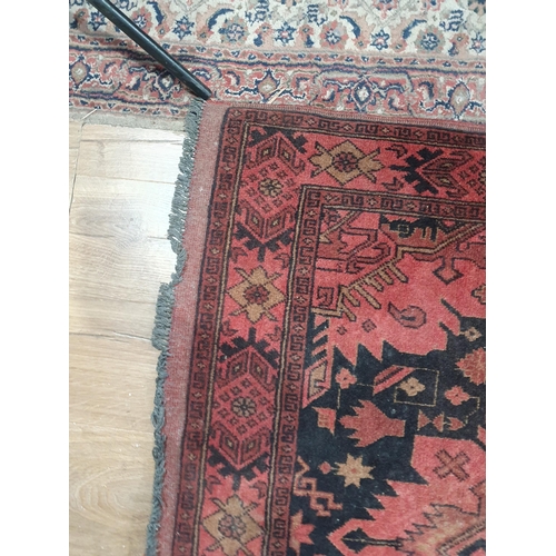 280 - A Wool Rug made in Pakistan with stylised motifs on a red ground 7ft 1in x 4ft 3in