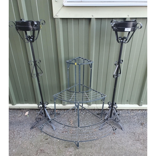 64 - A three tier painted metal Corner Plant Stand and a pair of black metal Stands with scrolled decorat... 